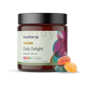 A jar of Medterra Daily Delight Gummies showcasing a label that declares "High Potency, Multi-Flavored" and containing 25MG CBD along with 5MG THC. The jar is topped with a black lid and adorned with vibrant designs. Beside the jar are four multicolored THC gummies in shades of green, red, orange, and yellow.