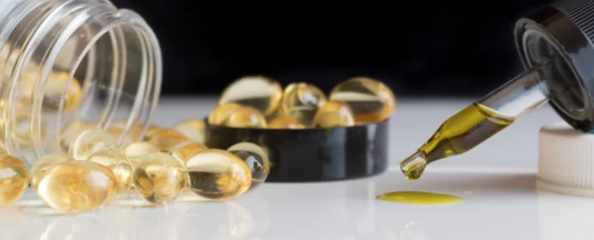 A dropper dispensing oil next to capsules on a table, related to Delta 9 THC.