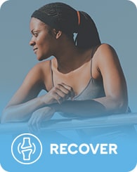 A woman with braided hair tied in a ponytail, wearing a sleeveless shirt, leans on a railing and looks into the distance. Below the image is an icon of a bone joint and the word "RECOVER" on a blue background.