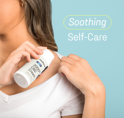 A woman in a white shirt applies Medterra's WM: Isolate 2,000mg Cream to her shoulder. The light blue background and "Soothing Self-Care" text emphasize the calming addition to her wellness routine.