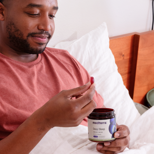 Deep Sleep CBD Gummies jar with 25mg CBD, 2mg THC, and melatonin, featuring mixed berry flavor.