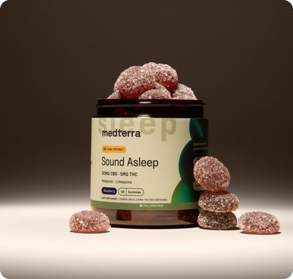 A jar of Medterra Rest & Restore Bundle is surrounded by scattered gummies. The label shows they contain CBD, THC, melatonin, L-theanine and have a blackberry flavor. It features a light green label with "High Potency.