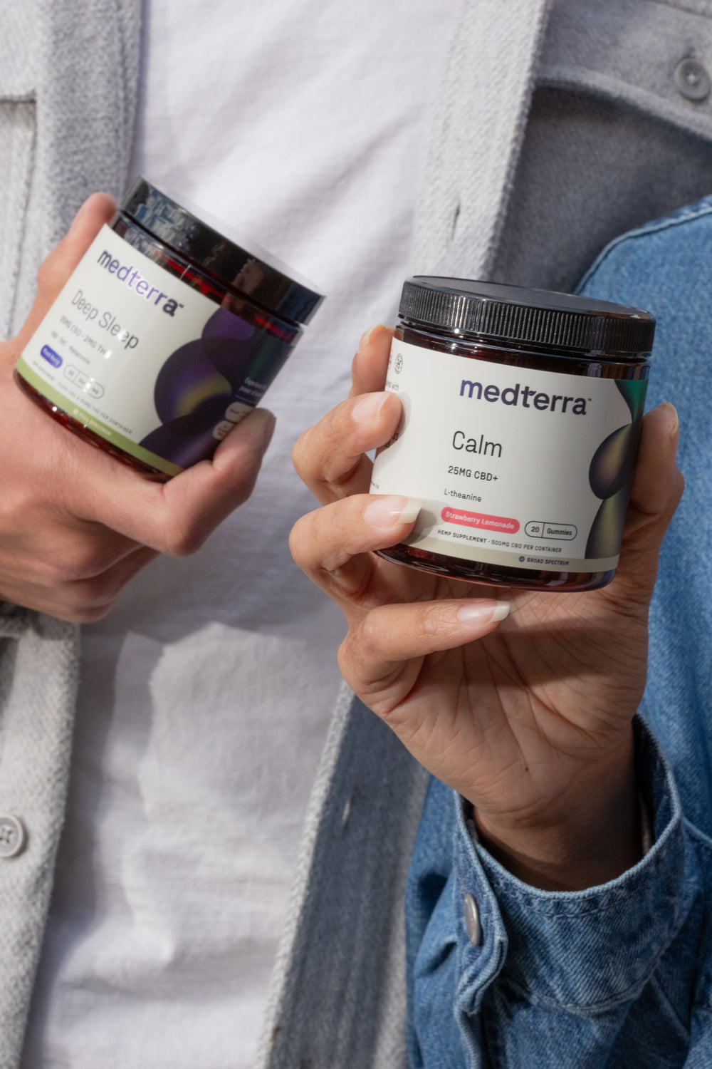 Two individuals are holding jars of Medterra CBD products. The person on the left has a jar labeled "Deep Sleep" with melatonin and chamomile, while the person on the right holds a jar labeled "Calm" with CBD and L-theanine. For more information, contact Medterra via email or phone. Both jars feature a modern design.